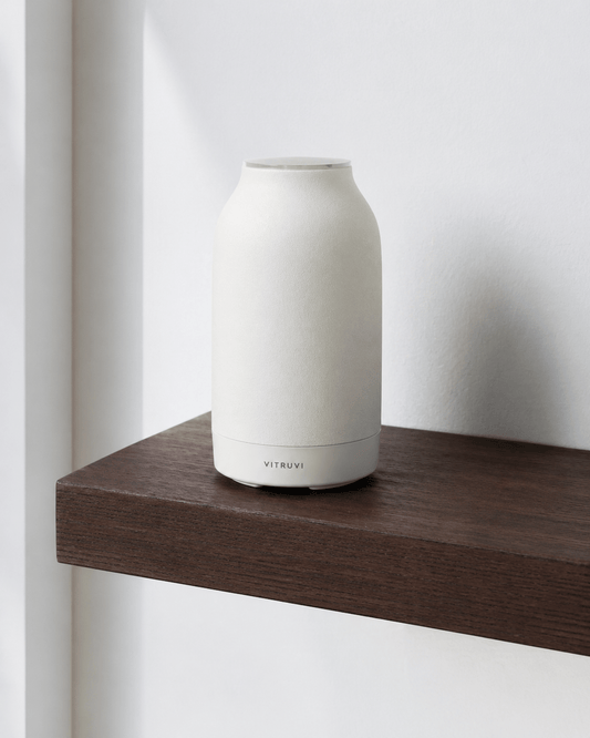 White Vitruvi waterless diffuser displayed on dark wood shelf