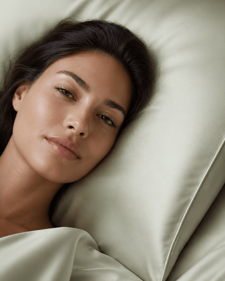 Sage green satin pillowcase for hair and skin care with smooth lustrous texture